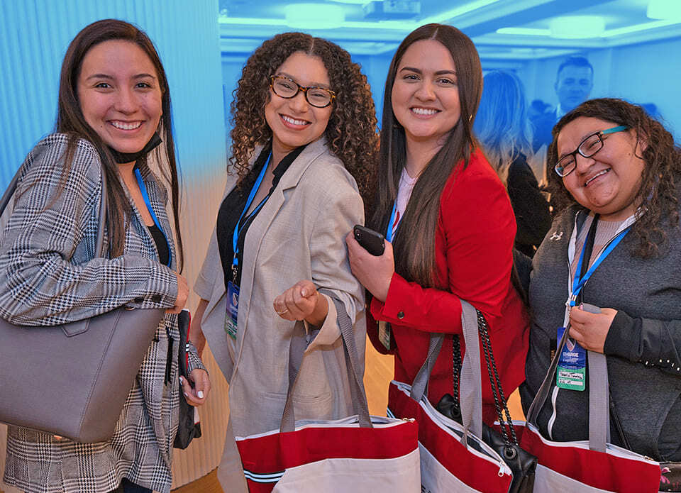 Four young women with their conference swag bags