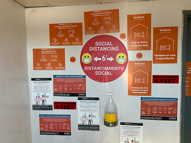 Entrance to Smithfield Foods facility with social distancing signage throughout the facility. 